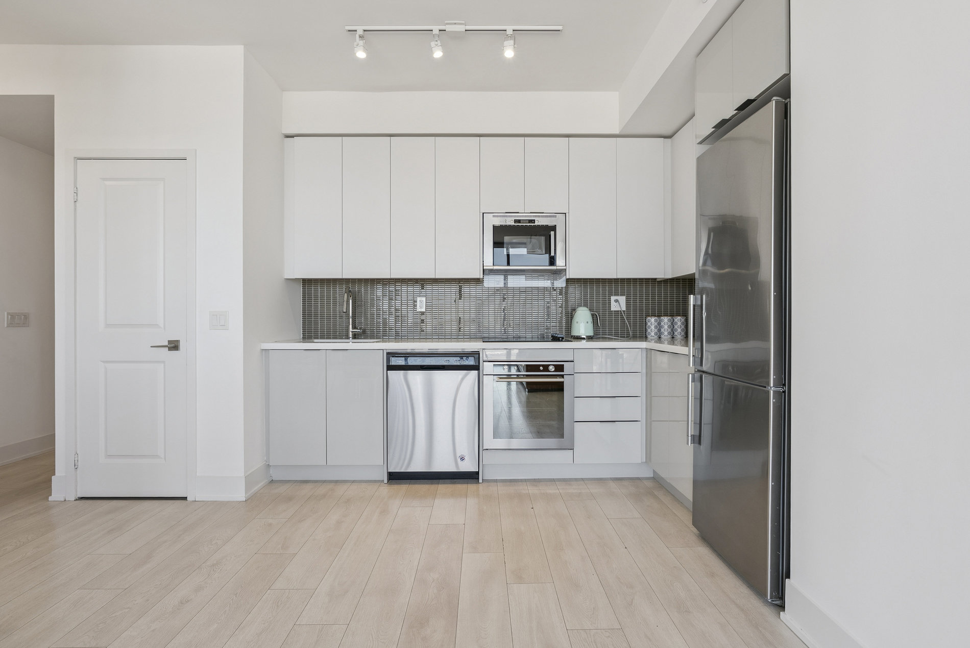 Kitchen with quartz counters and backsplash