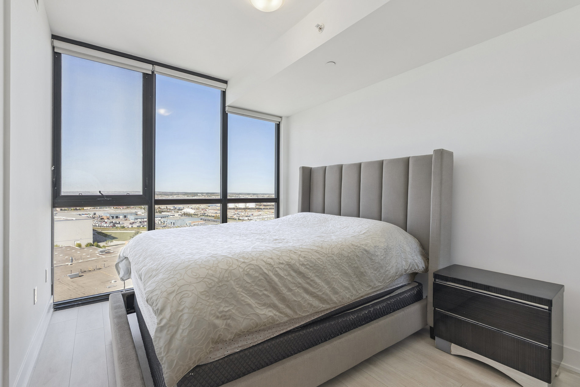 Primary bedroom with floor-to-ceiling windows and views