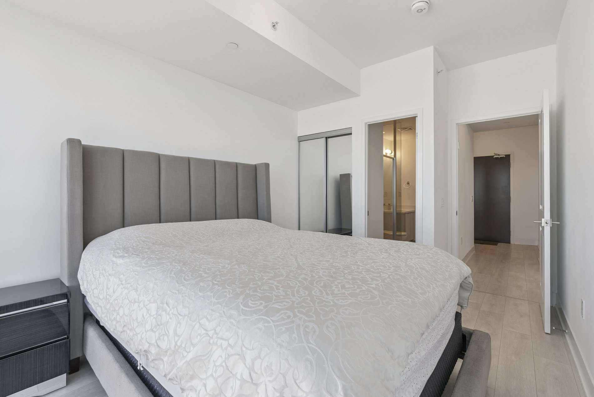 Primary bedroom with ensuite bathroom and mirrored closet