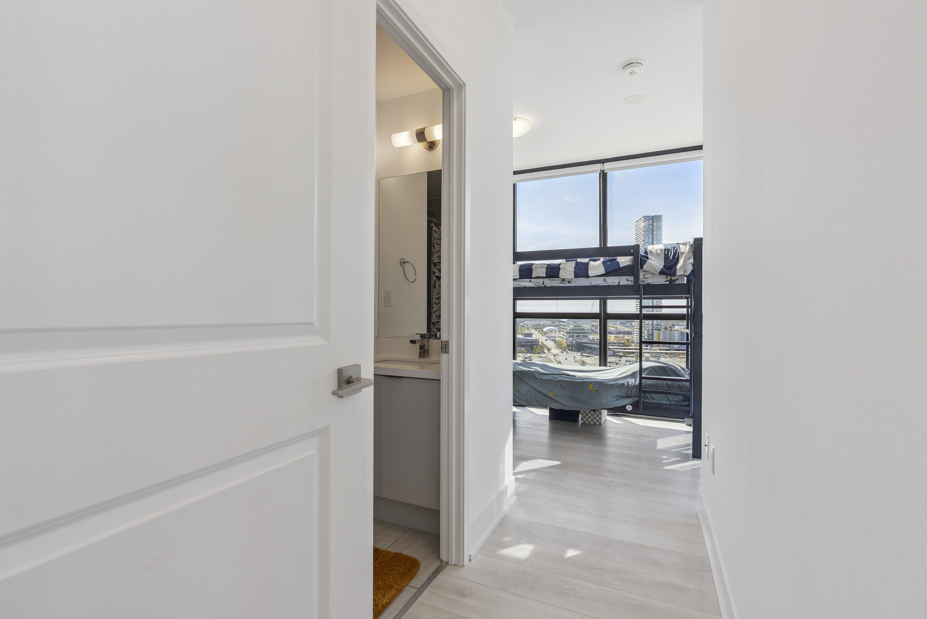 Hallway with bedroom and ensuite bathroom access