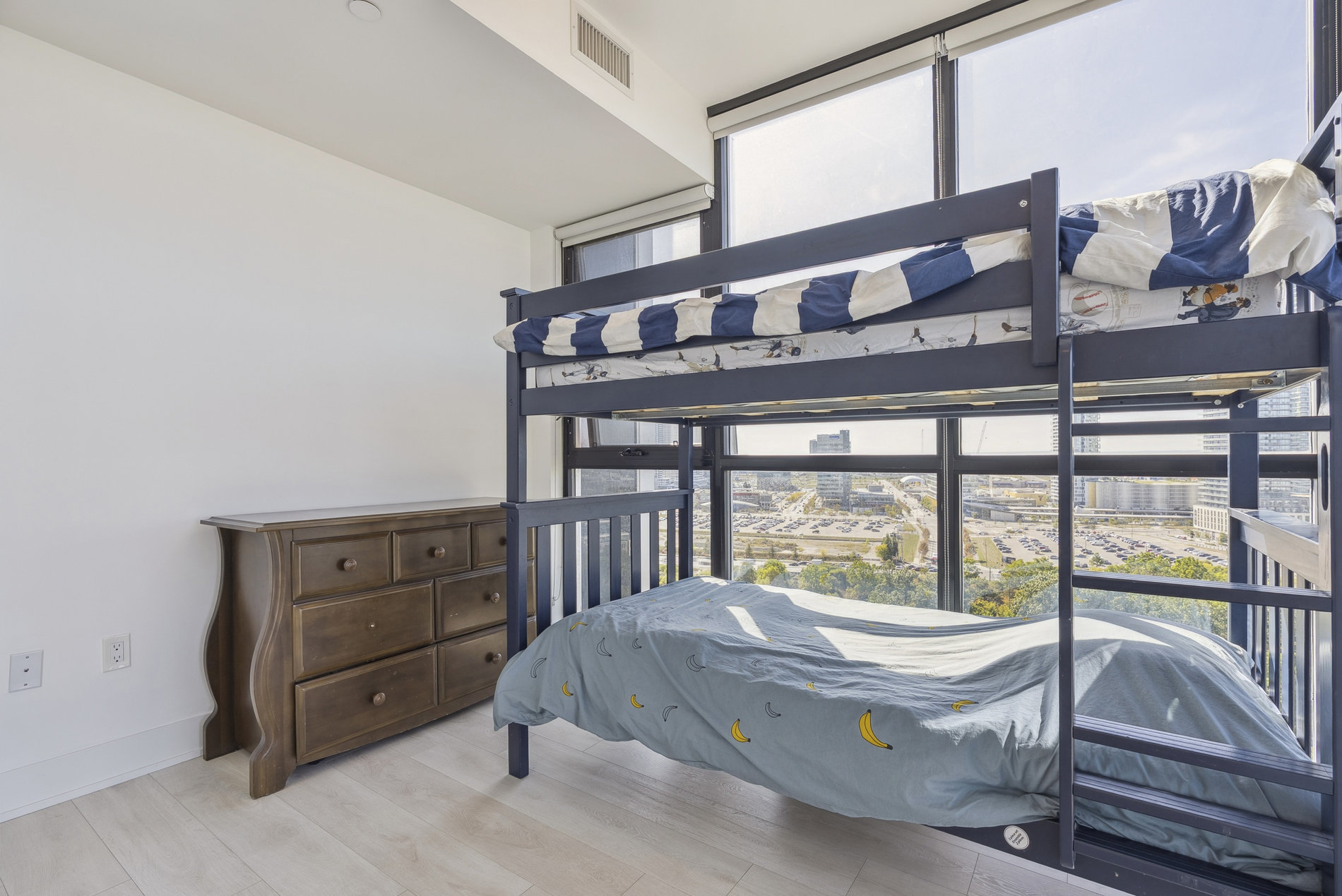 Second bedroom with bunk bed and city views