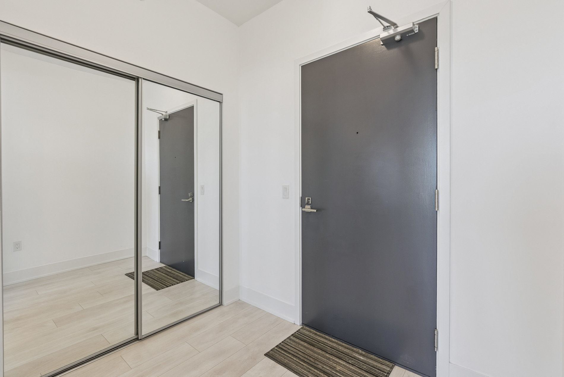 Inviting foyer with double mirrored closet